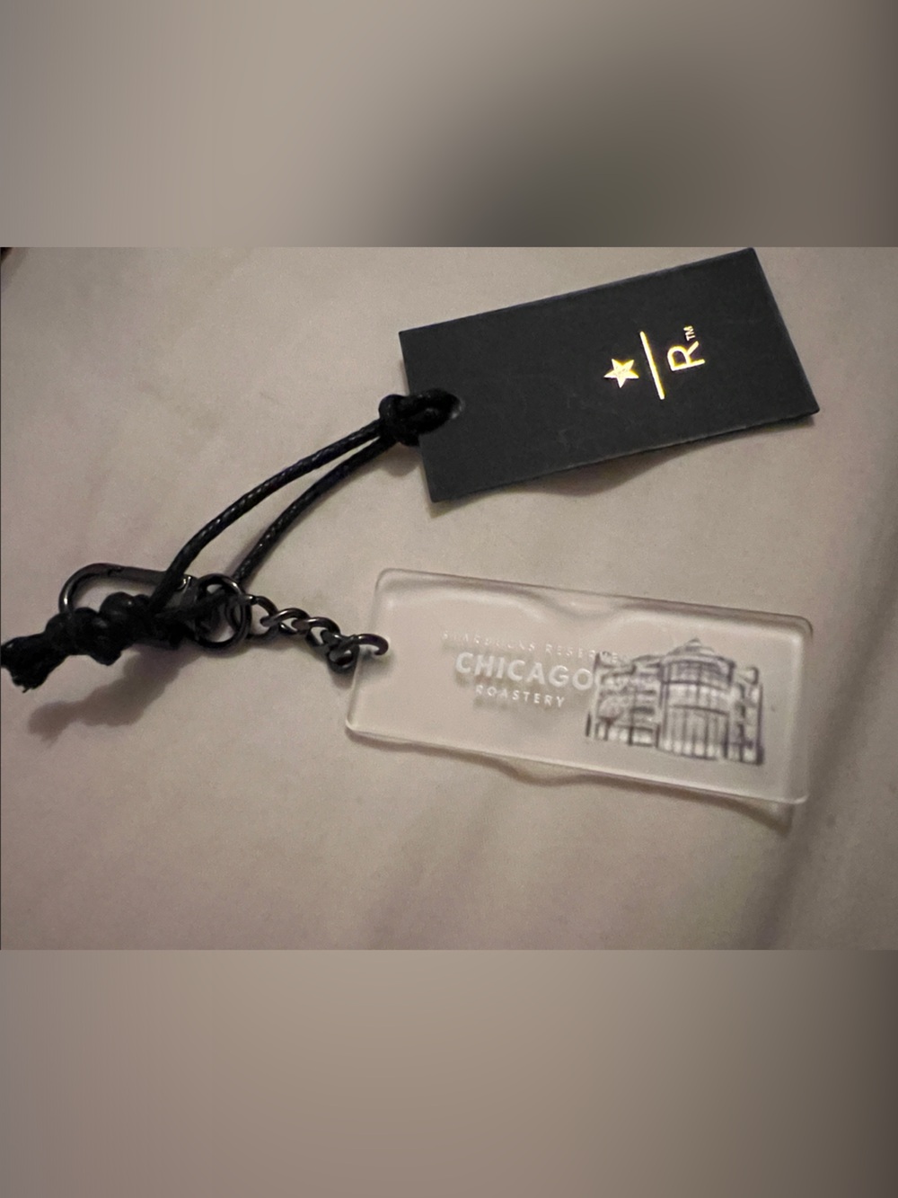 Starbucks clear acrylic Chicago Roastery keychain with black cord and tag